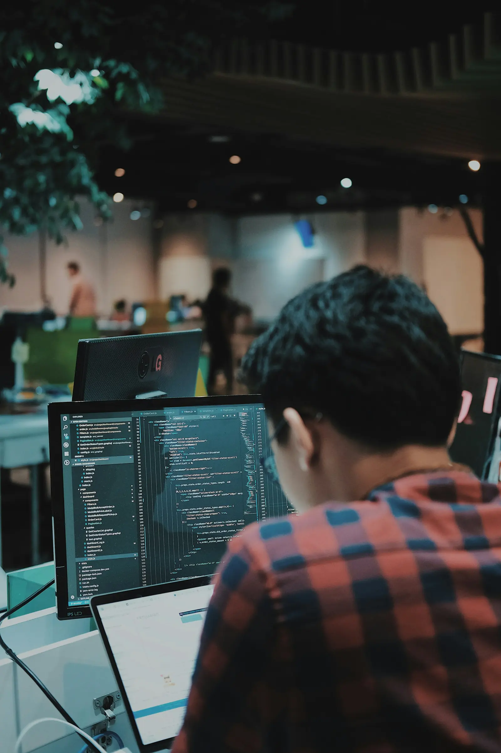 A developer writing code at a workstation